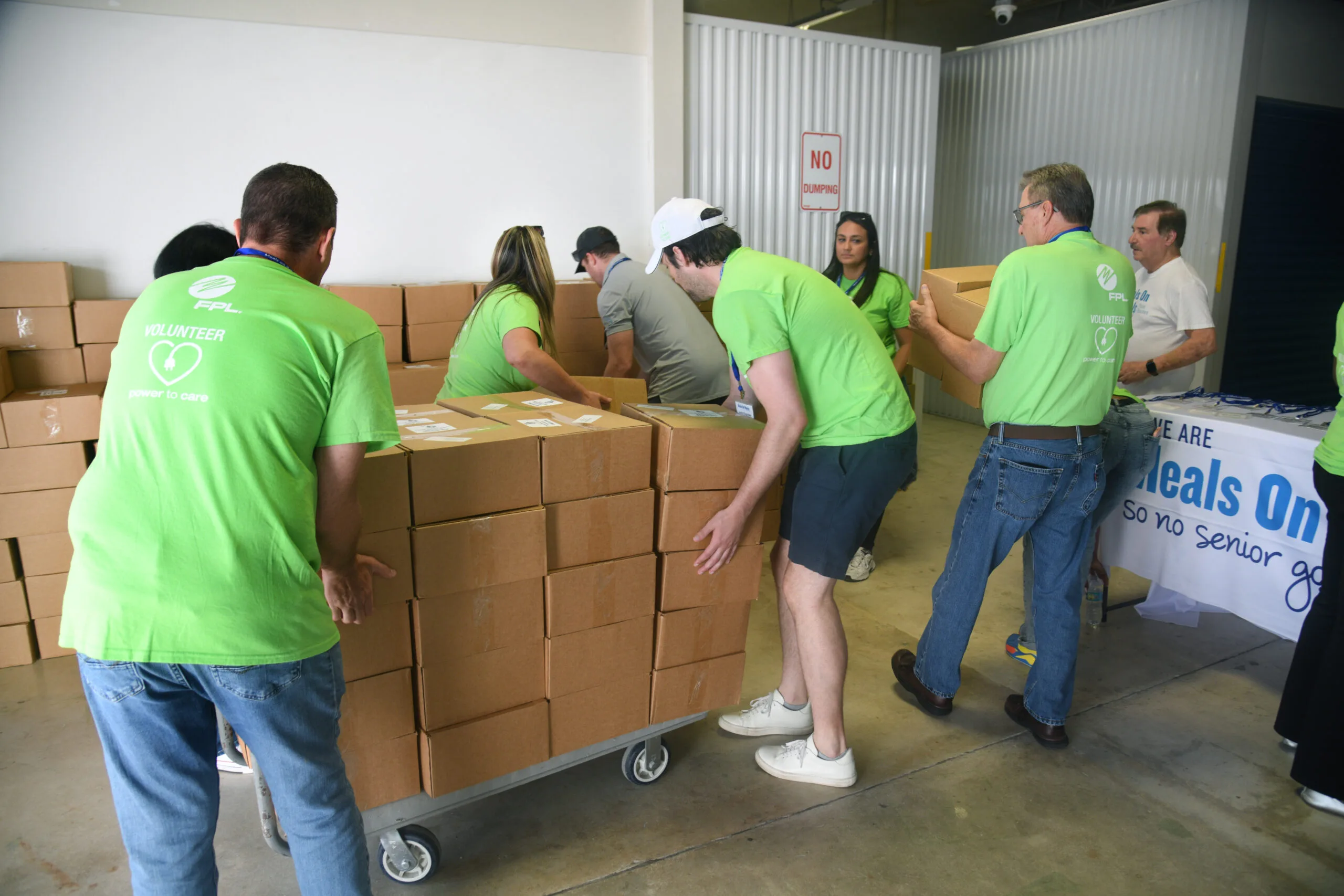 1-Florida-Power-Light-Company-volunteers-packed-hurricane-preparedness-meal-kits-for-seniors-in-Palm-Beach-County.--scaled